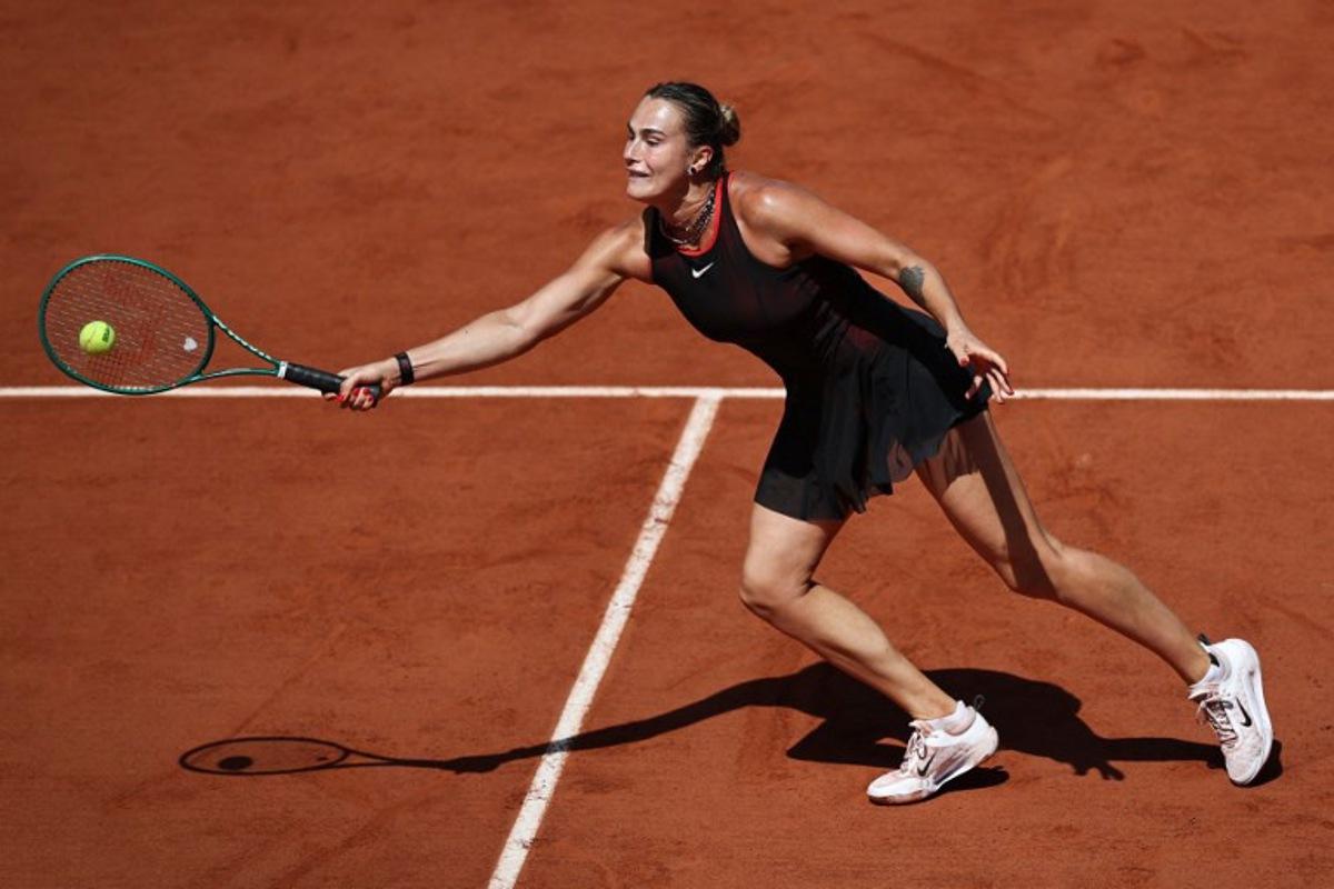 Aryna Sabalenka plays a forehand return to Australia's Daria Kasatkina during their women's singles match on day 7 of the French Open tennis tournament on Court Suzanne-Lenglen at the Roland-Garros Complex in Paris on May 30, 2026.  Anne-Christine POUJOULAT / AFP