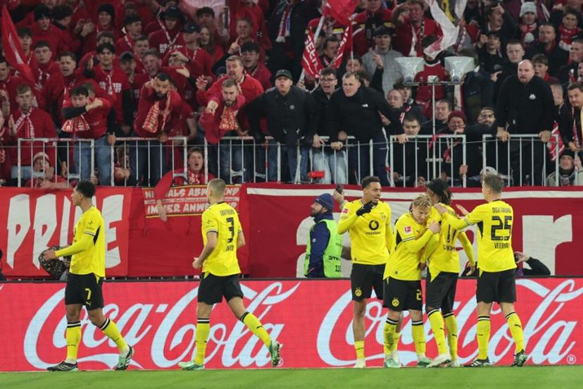 Dortmund's English midfielder #07 Jobe Bellingham (L) celebrates scoring with his teammates before the goal was disallowed for offside by VAR during the German first division Bundesliga football match between FC Bayern Munich and BVB Borussia Dortmund in Munich, southern Germany, on October 31, 2026.  Alexandra BEIER / AFP