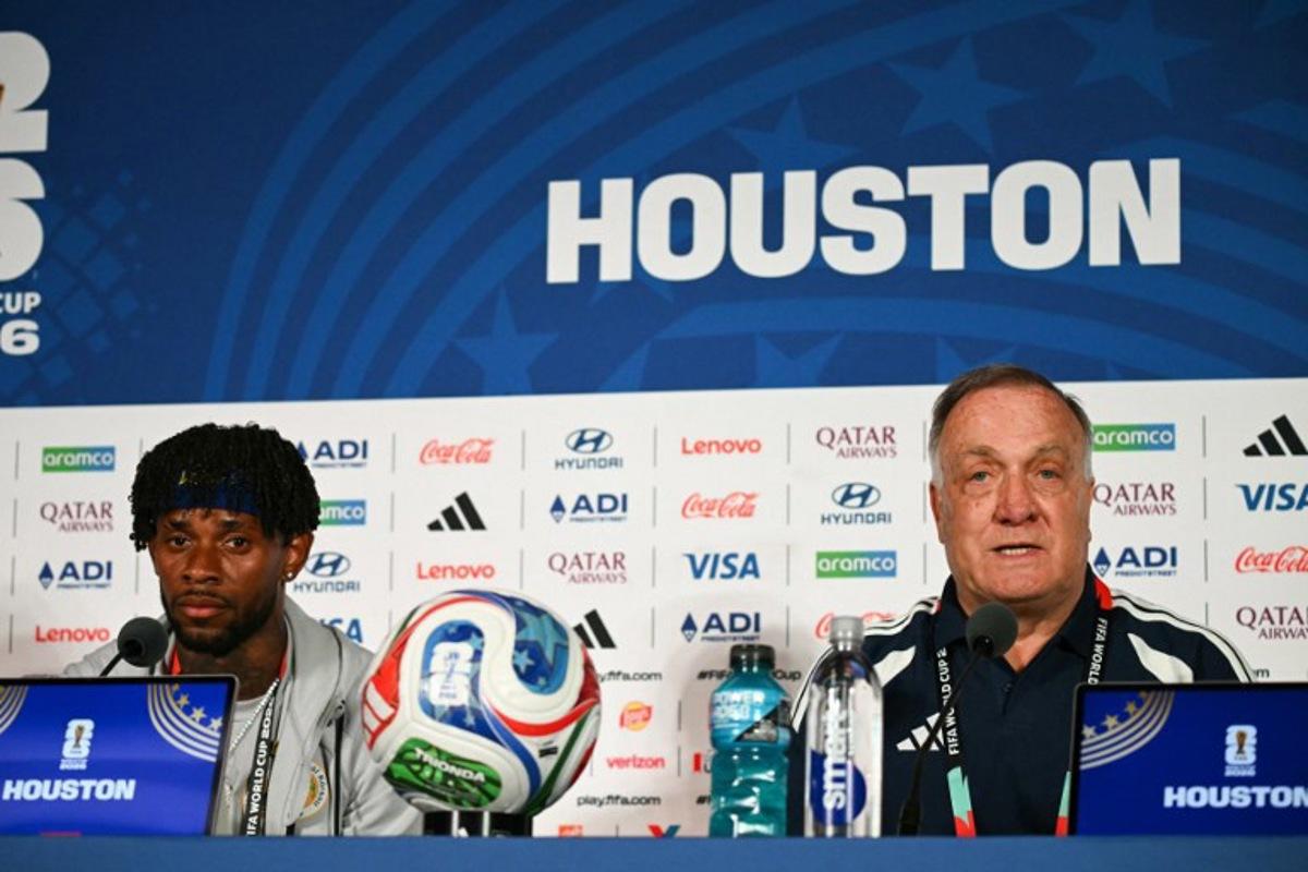Curacao's Dutch head coach Dick Advocaat (R) gives a press conference next to Curacao's midfielder #10 Leandro Bacuna on the eve of Curacao's 2026 World Cup football tournament Group E football match against Germany in Houston on June 13, 2026.   Ronaldo SCHEMIDT / AFP