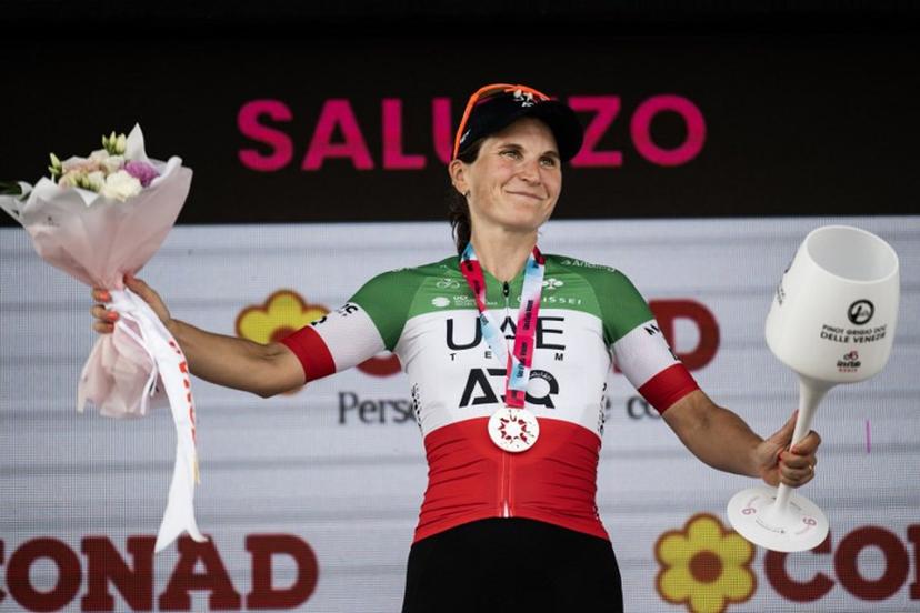 UAE Italian rider Elisa Longo Borghini poses on the podium after winning the 9th stage of the Giro d'Italia Women 2026 - Tour of Italy Women cycling race between Saluzzo and Saluzzo, Italy, on June 7, 2026.  MARCO BERTORELLO / AFP