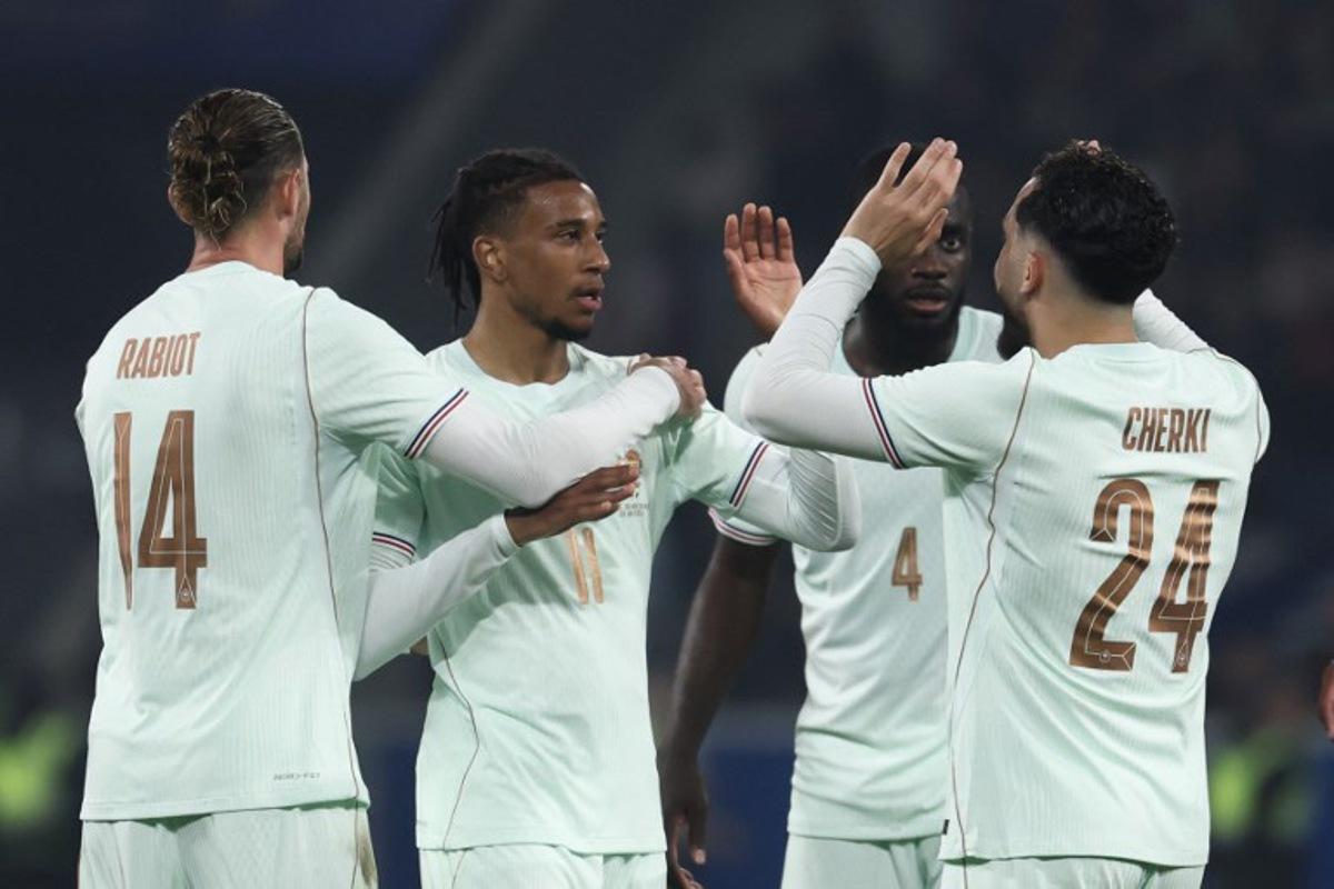 France's forward #11 Michael Olise (2L) celebrates scoring his team's third goal with France's midfielder #14 Adrien Rabiot (L) and France's defender #04 Dayot Upamecano and France's forward #24 Rayan Cherki (R) during the international friendly football match between France and North Ireland at the Decathlon Arena - Pierre Mauroy stadium in Villeneuve-d'Ascq, northern France on June 8, 2026, ahead of the 2026 FIFA World Cup football tournament.  FRANCK FIFE / AFP