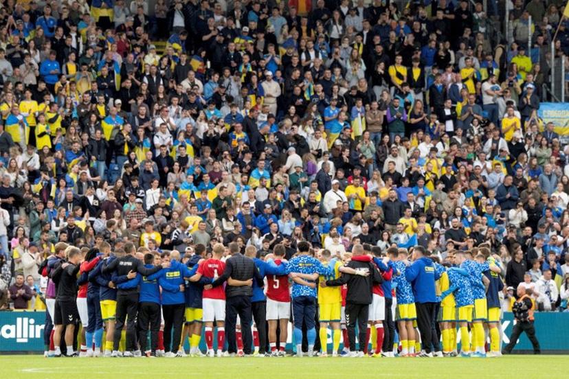 Denmark's and Ukraine's players huddle on the pitch during the football international friendly match between Denmark and Ukraine at Odense Stadium in Denmark, on June 7, 2026. Christian Eriksen collapsed during Denmark's friendly against Ukraine on June 7, 2026, five years after he suffered a cardiac arrest during the European Championships. Bo Amstrup / AFP