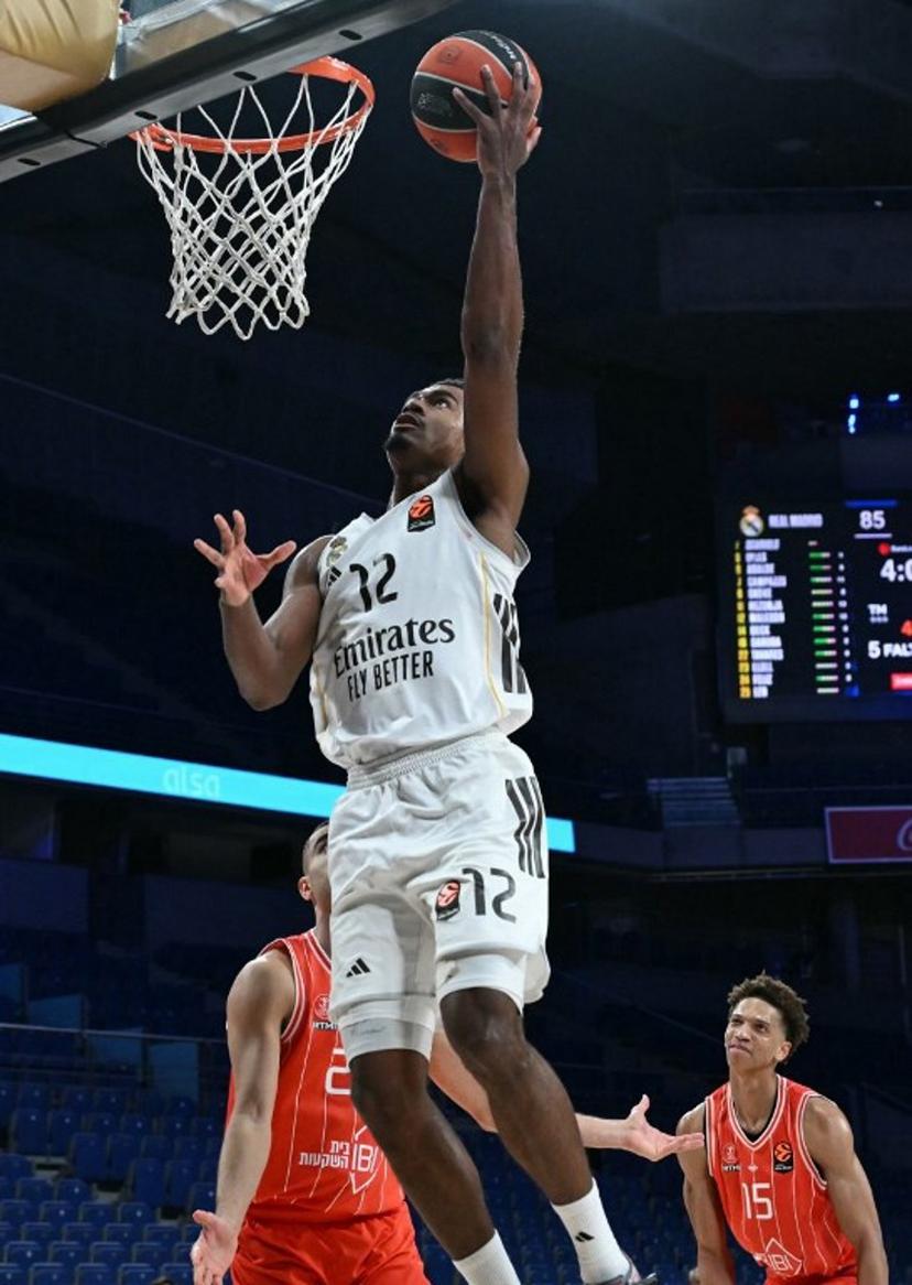 Real Madrid's French guard #12 Theo Maledon goes up to the basket during the empty-stadium Euroleague basketball match between Real Madrid Baloncesto and Hapoel IBI Tel-Aviv at the Movistar arena in Madrid on March 24, 2026.   Javier SORIANO / AFP