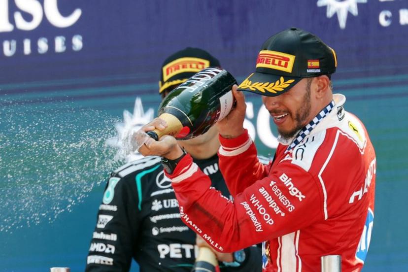 Winner Ferrari's British driver Lewis Hamilton (R) and second placed Mercedes' British driver George Russell celebrate in the podium after the Catalonia Formula One Grand Prix at the Circuit de Catalunya in Montmelo, on the outskirts of Barcelona, on June 14, 2026.  Lluis GENE / AFP
