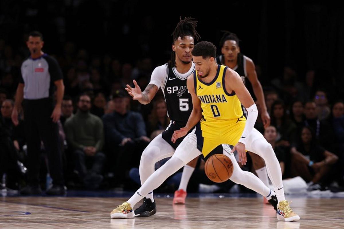 Indian Pacer's US Guard #0 Tyrese Haliburton (R) dribbles the ball as San Antonio Spurs' US guard #05 Stephon Castle (L)  during the NBA basketball game between the San Antonio Spurs and the Indiana Pacers at the Accor Arena - Palais Omnisports de Paris-Bercy - in Paris on January 25, 2025.  FRANCK FIFE / AFP