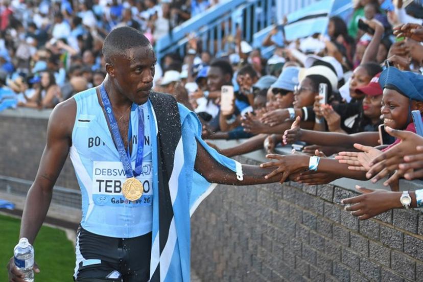 Botswana's Letsile Tebogo celebrates with fans after winning the men's 4x400m relay final during the Gaborone 26 World Athletics Relays at the National Stadium in Gaborone on May 3, 2026.  AFP