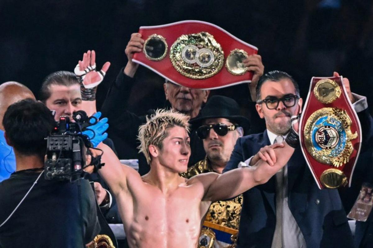 Naoya Inoue (C) celebrates defeating Junto Nakatani in their super bantamweight championship boxing contest at Tokyo Dome in Tokyo on May 2, 2026.  Yuichi YAMAZAKI / AFP