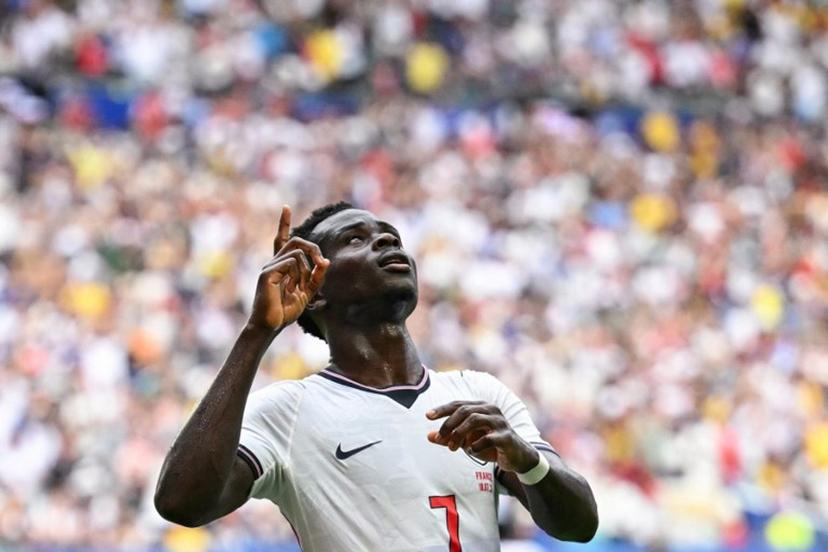 England's forward #07 Bukayo Saka celebrates scoring his team's fourth goal during the 2026 World Cup football tournament third-place match between France and England at the Miami Stadium in Miami on July 18, 2026.   CHANDAN KHANNA / AFP