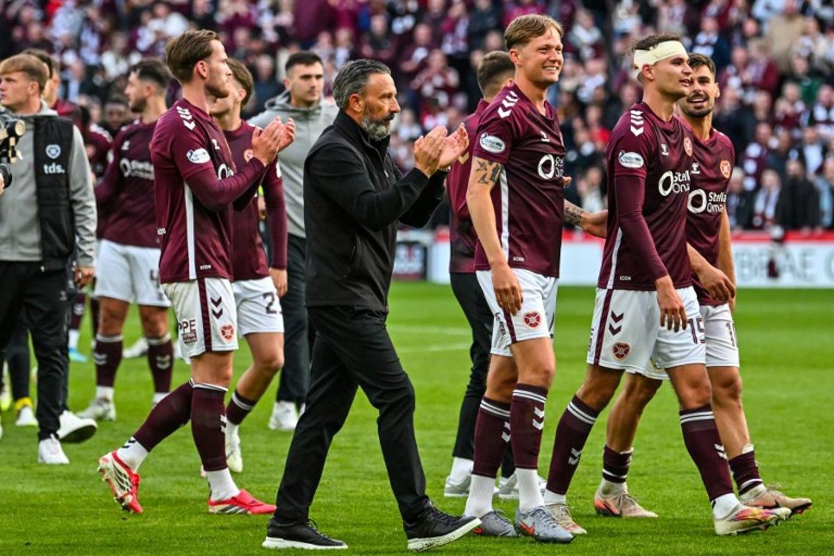 Hearts Scottish manager Derek McInnes (C) and players react after the final whistle in the Scottish Premiership football match between Hearts and Rangers at Tynecastle Stadium in Edinburgh on May 4, 2026. Hearts are hoping to become the first club other than Celtic and Rangers to win the Scottish crown since Aberdeen in 1985. ANDY BUCHANAN / AFP