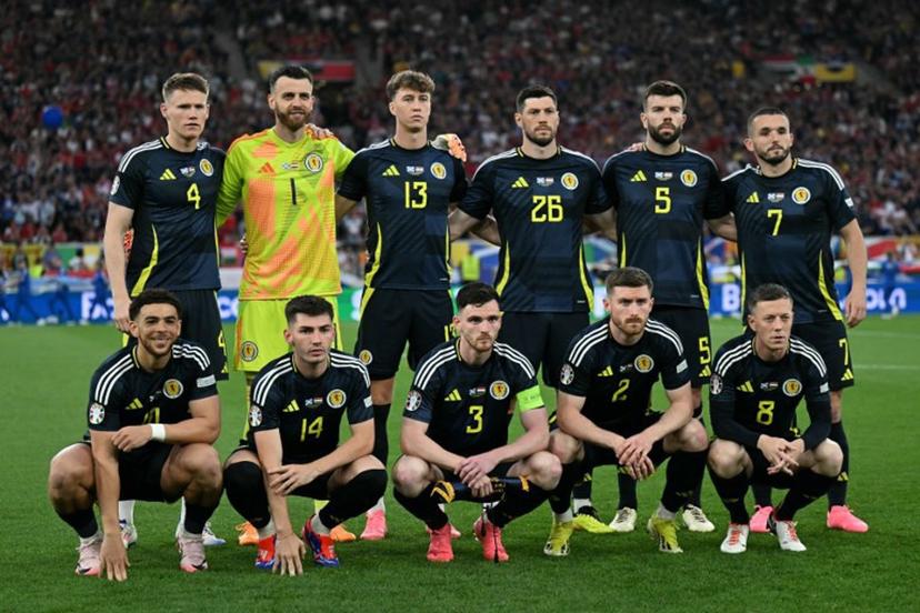 (From L) Scotland's forward #10 Che Adams, Scotland's midfielder #04 Scott McTominay, Scotland's goalkeeper #01 Angus Gunn, Scotland's midfielder #14 Billy Gilmour, Scotland's defender #13 Jack Hendry, Scotland's defender #03 Andrew Robertson, Scotland's defender #26 Scott McKenna, Scotland's defender #02 Anthony Ralston, Scotland's defender #05 Grant Hanley, Scotland's midfielder #07 John McGinn and Scotland's midfielder #08 Callum McGregor pose for photographers ahead of the UEFA Euro 2024 Group A football match between Scotland and Hungary at the Stuttgart Arena in Stuttgart on June 23, 2024.  Fabrice COFFRINI / AFP