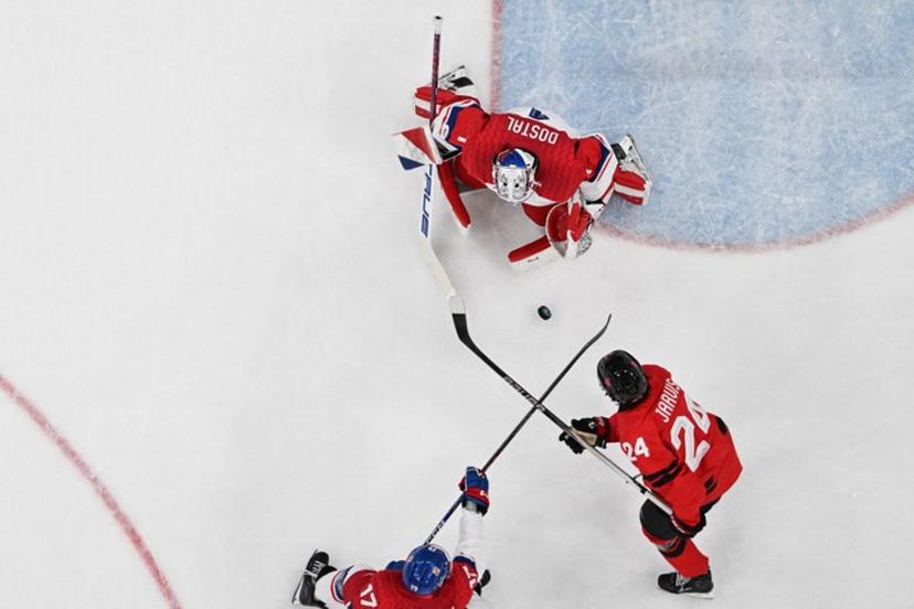 Czech Republic's #17 Filip Hronek (L) fights for the puck with Canada's #24 Seth Jarvis (R) in front of Czech Republic's goalkeeper #01 Lukas Dostal (C) during the men's play-off quarter-final ice hockey match between Canada and Czech Republic at the Milano Santagiulia Ice Hockey Arena during the Milano Cortina 2026 Winter Olympic Games in Milan, on February 18, 2026.  Alexander NEMENOV / AFP