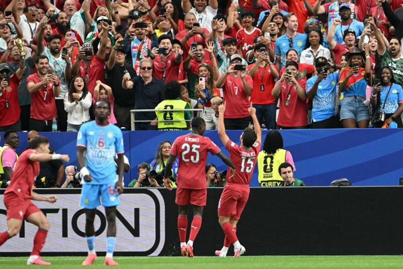 Portugal's midfielder #15 Joao Neves (R) celebrates after scoring the opening goal during the 2026 World Cup Group K football match between Portugal and the Democratic Republic of Congo at the Houston Stadium in Houston on June 17, 2026.   RONALDO SCHEMIDT / AFP