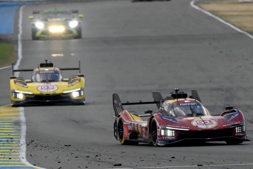 Ferrari AF Corse Thor Team's hypercar #51 Italian driver Antonio Gioninazzi (R) and Ferrari AF Corse Thor Team's hypercar #83 Polish driver Robert Kubica compete in the 24 Hours of Le Mans 2025, at the Le Mans circuit, north-western France, on June 15, 2025.   JEAN-FRANCOIS MONIER / AFP
