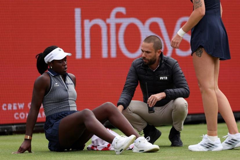 Canada's Victoria Mboko reacts after slipping on the grass attempting to play a return shot against Czech Republic's Karolina Pliskova during their round of 16 women's singles match at the HSBC WTA tennis Championships at Queen's Club in west London on June 10, 2026. Pliskova won the match 6-2, 3-4 after Mboko retired in the second set. Adrian Dennis / AFP