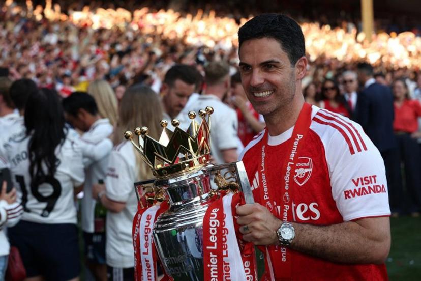 Arsenal's Spanish manager Mikel Arteta poses with the Premier League trophy at a presentation ceremony  on the pitch after the English Premier League football match between Crystal Palace and Arsenal at Selhurst Park in south London on May 24, 2026. Arsenal are English league champions for the first time since 2004, winning the league by seven points. Adrian Dennis / AFP