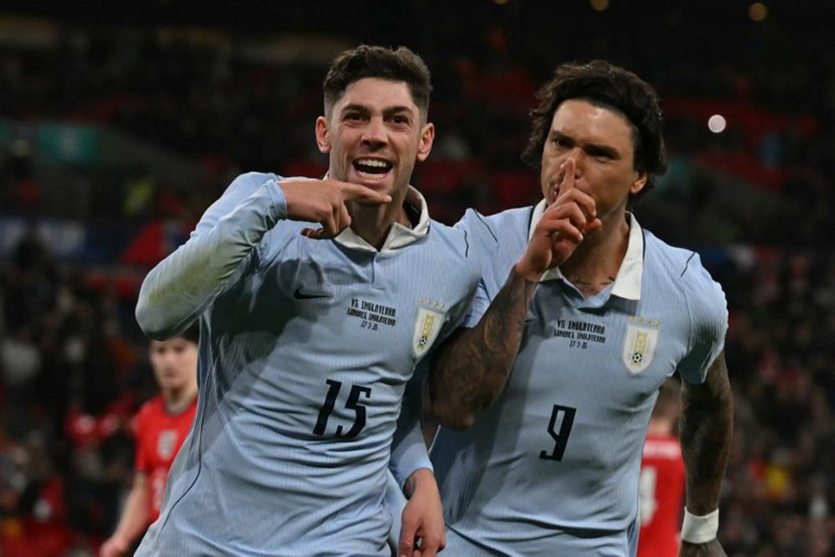 Uruguay's midfielder Federico Valverde (L) celebrates with Uruguay's forward Darwin Nunez (R) after scoring their first goal from the penalty spot during the friendly International football match between England and Uruguay at Wembley Stadium, west London, on March 27, 2026.  Glyn KIRK / AFP