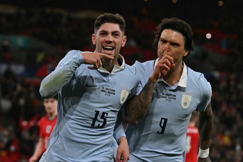 Uruguay's midfielder Federico Valverde (L) celebrates with Uruguay's forward Darwin Nunez (R) after scoring their first goal from the penalty spot during the friendly International football match between England and Uruguay at Wembley Stadium, west London, on March 27, 2026.  Glyn KIRK / AFP