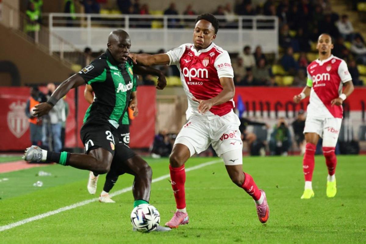 Lens' French defender #20 Malang Sarr (L) fights for the ball with Monaco's French forward #21 Lucas Michal during the French L1 football match between AS Monaco and RC Lens at the Stade Louis II in the Principality of Monaco on November 8, 2025.  Clement MAHOUDEAU / AFP