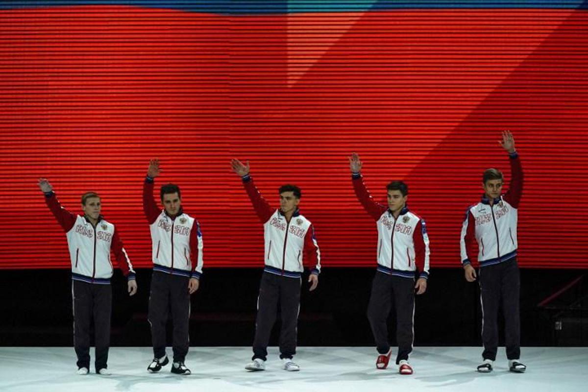 The Russian team wave as they arrive for the men?s team final at the FIG Artistic Gymnastics World Championships at the Hanns-Martin-Schleyer-Halle in Stuttgart, southern Germany, on October 9, 2019. Russia won the Gold medal ahead of China (Silver) and Japan (Bronze). Lionel BONAVENTURE / AFP