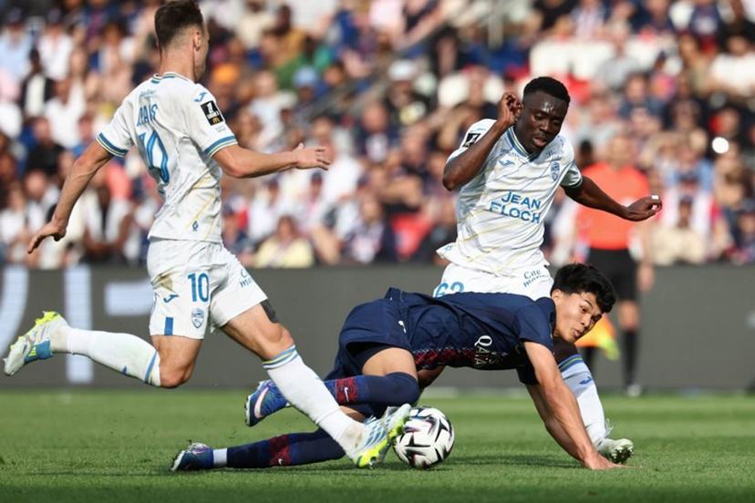 Paris Saint-Germain's Spanish midfielder #27 Dro Fernandez (C) fights for the ball with Lorient's French midfielder #10 Pablo Pagis (L) and Cameroonian midfielder #62 Arthur Avom (R) during the French L1 football match between Paris Saint-Germain (PSG) and FC Lorient at Parc des Princes stadium in Paris on May 2, 2026.  FRANCK FIFE / AFP