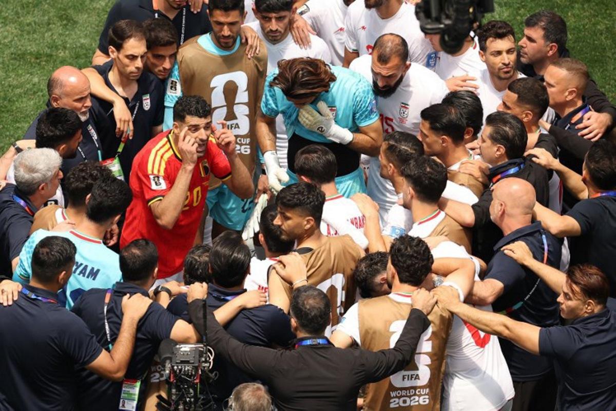 Iran's forward #09 Mehdi Taremi wearing the jersey of Belgium's midfielder #20 Hans Vanaken talks with his teammates at the end of the 2026 World Cup Group G football match between Belgium and Iran at the Los Angeles Stadium in Inglewood on June 21, 2026.   Etienne Laurent / AFP