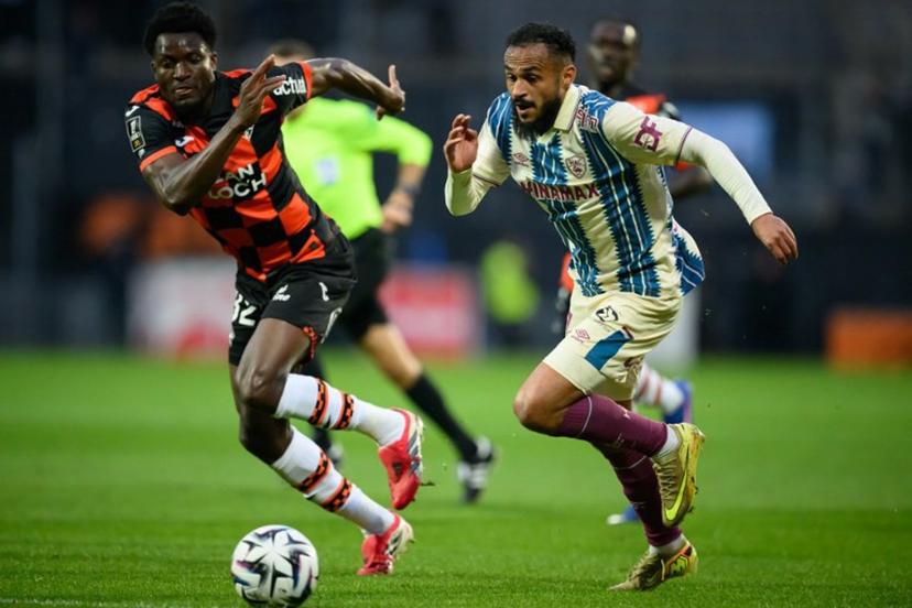 Lorient's Ghanaian defender #32 Nathaniel Adjei fights for the ball with Le Havre's Moroccan midfielder #17 Sofiane Boufal during the French L1 football match between FC Lorient and Le Havre Athletic Club at Yves-Allainmat stadium in Lorient, western France on May 17, 2026.   Loic VENANCE / AFP