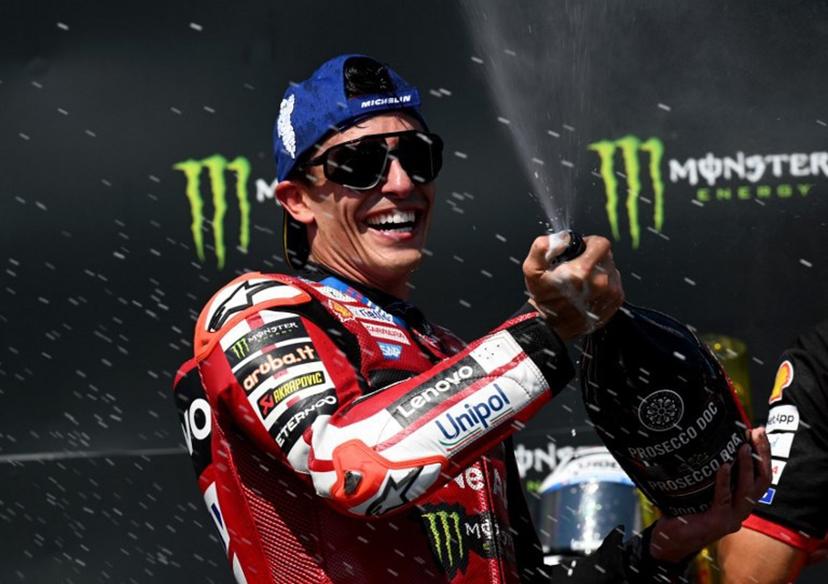 Team Ducati Lenovo Team's Marc Marquez celebrates on the podium with sparkling wine after winning the MotoGP Grand Prix of Czechia in Brno, Czech Republic, on June 21, 2026.  Michal Cizek / AFP