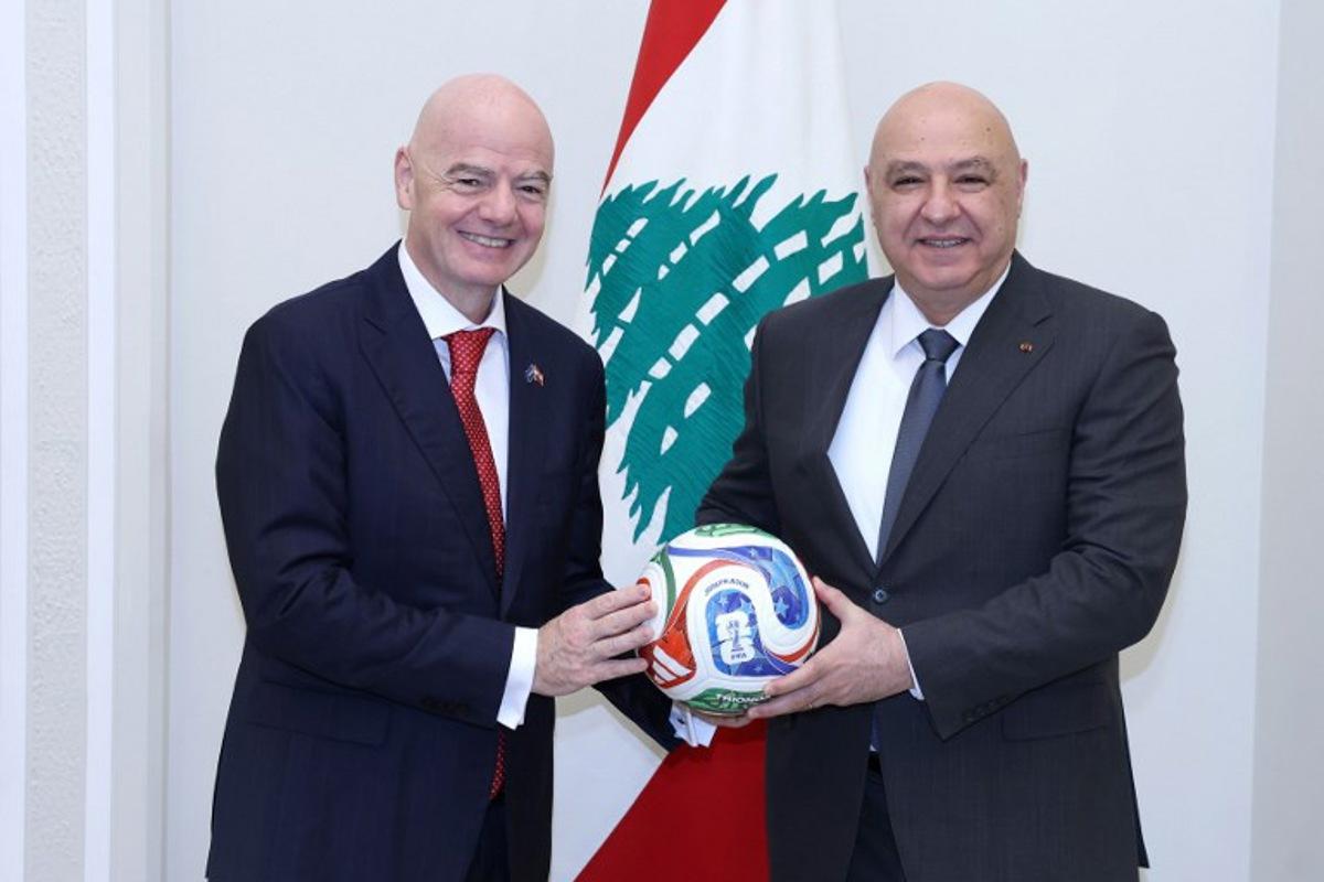 A handout photograph released by the Lebanese Presidency's press office shows FIFA president Gianni Infantino posing with Lebanese President Joseph Aoun (R) after their meeting at the presidential palace of Baabda, east of Beirut, on November 25, 2025.  HANDOUT / Lebanese Presidency / AFP