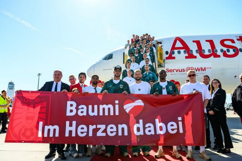 Members of Austria's national football team hold a banner reading "Baumi - with us in our hearts", addressing injured team player Christoph Baumgartner nicknamed "Baumi" who will miss the World Cup due to injury, as the team boards a plane before departing from the Schwechat airport near Vienna, Austria, on June 4, 2026, ahead of the FIFA 2026 World Cup.  MAX SLOVENCIK / APA / AFP