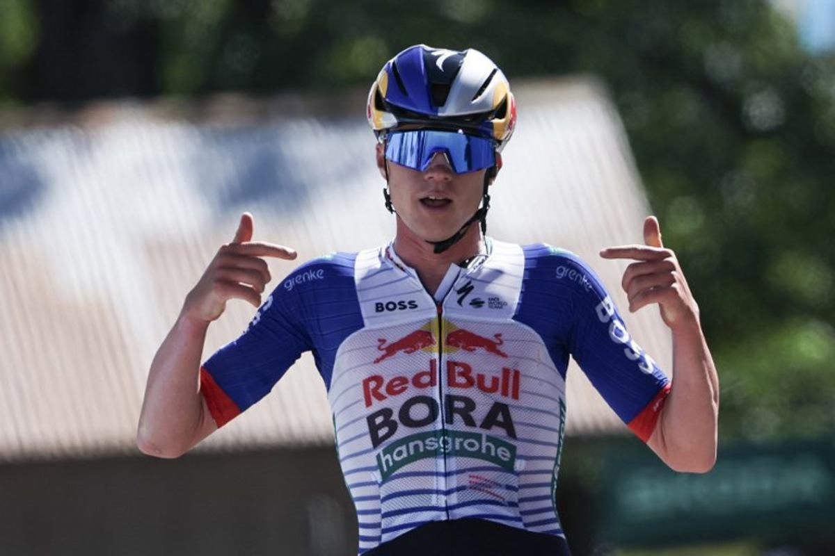 Red Bull - Bora - Hansgrohe's Belgian rider Maxim Van Gils celebrates as he cycles across the finish line to win the 6th stage of the Tour Auvergne-Rhone-Alpes cycling race (formerly known as the Criterium du Dauphine), 182,3km between Saint-Vulbas and Crest-Voland in the French Alps on June 12, 2026.  Anne-Christine POUJOULAT / AFP
