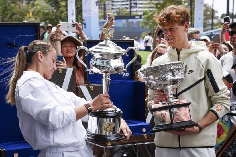 Current Australian Open tennis champions Aryna Sabalenka (L) of Belarus and Italy's Jannik Sinner hold the trophies as part of an offical ceremony for the main draw, ahead of the Australian Open tennis tournament in Melbourne on January 9, 2025.  DAVID GRAY / AFP