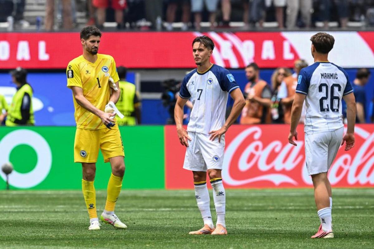 Bosnia-Herzegovina's goalkeeper #01 Nikola Vasilj, defender #07 Amar Dedic, and midfielder #26 Ermin Mahmic react after losing the 2026 World Cup Group B football match between Switzerland and Bosnia and Herzegovina at Los Angeles Stadium in Inglewood on June 18, 2026.   Patrick T. Fallon / AFP
