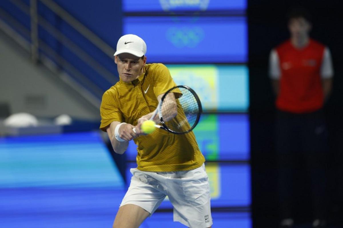 Italy's Jannik Sinner hits a return against Czech Republic's Jakub Mensik during their men's singles quarterfinal match at the Qatar Open tennis tournament in Doha on February 19, 2026.  Karim JAAFAR / AFP