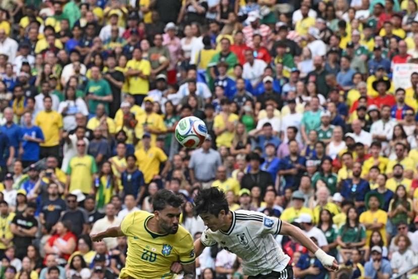 Brazil's midfielder #20 Lucas Paqueta (L) fights for the ball with Japan's defender #03 Shogo Taniguchi during the 2026 World Cup round of 32 football match between Brazil and Japan at the Houston Stadium in Houston on June 29, 2026.   RONALDO SCHEMIDT / AFP