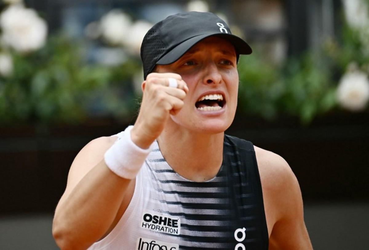 Poland's Iga Swiatek celebrates after winning against USA's Jessica Pegula during the ATP Rome Open tennis tournament at Foro Italico in Rome on May 13, 2026.   Filippo MONTEFORTE / AFP
