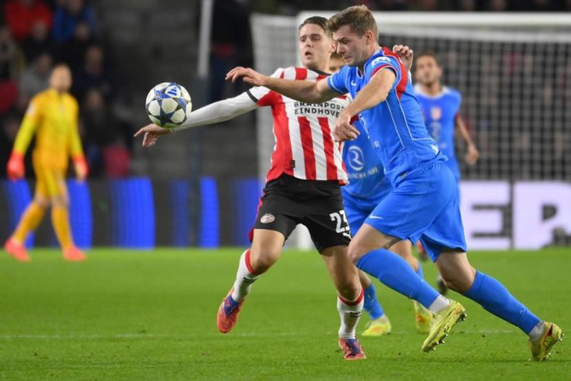 PSV Eindhoven's Dutch midfielder #23 Joey Veerman (L) fights for the ball with Atletico Madrid's Norwegian forward #09 Alexander Sorloth during the UEFA Champions League, league phase day 6, football match between PSV Eindhoven (NED) and Atletico Madrid (ESP), at the Philips Stadion, in Eindhoven, south of The Netherlands, on December 9, 2025.  JOHN THYS / AFP