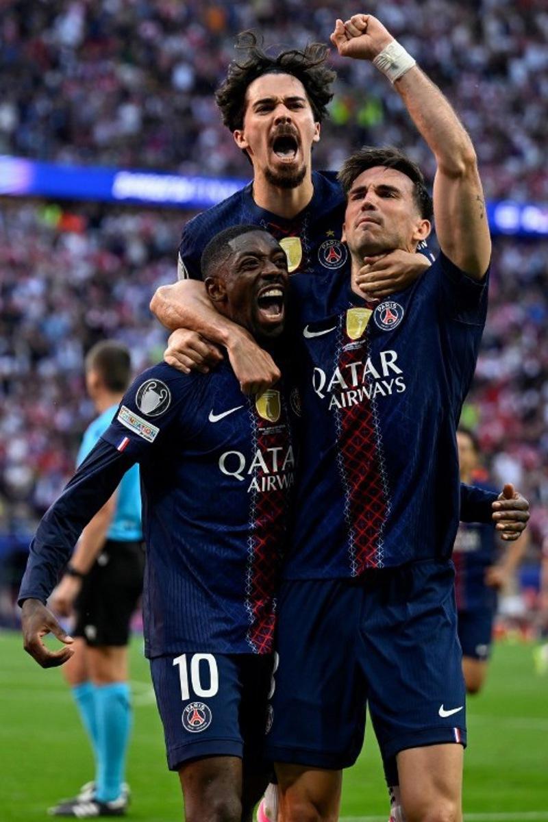 Paris Saint-Germain's French forward #10 Ousmane Dembele (L) celebrates after scoring his team's first goal after penalty with Paris Saint-Germain's Portuguese midfielder #17 Vitinha (C) and Paris Saint-Germain's Spanish midfielder #08 Fabian Ruiz during the UEFA Champions League final football match between Paris Saint-Germain (PSG) and Arsenal FC at the Puskas Arena in Budapest on May 30, 2026.   INA FASSBENDER / AFP