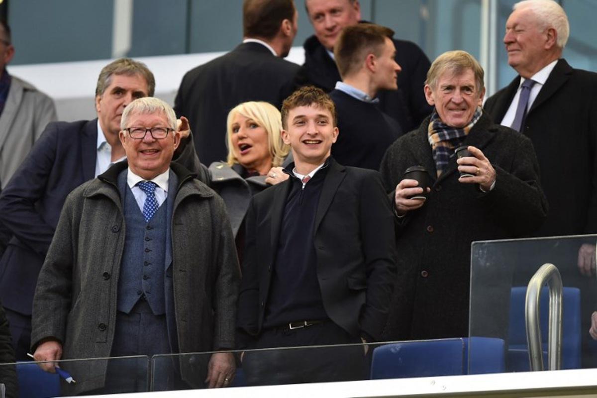 Former manager of Manchester United Alex Ferguson (L) and former manager of Liverpool Kenny Dalglish (R) take their seats for the friendly international football match between Scotland and Ivory Coast at the Hill Dickinson Stadium in Liverpool, north west England on March 31, 2026.    PETER POWELL / AFP
