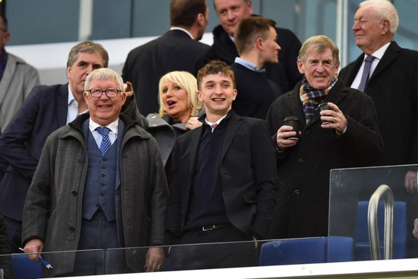 Former manager of Manchester United Alex Ferguson (L) and former manager of Liverpool Kenny Dalglish (R) take their seats for the friendly international football match between Scotland and Ivory Coast at the Hill Dickinson Stadium in Liverpool, north west England on March 31, 2026.    PETER POWELL / AFP