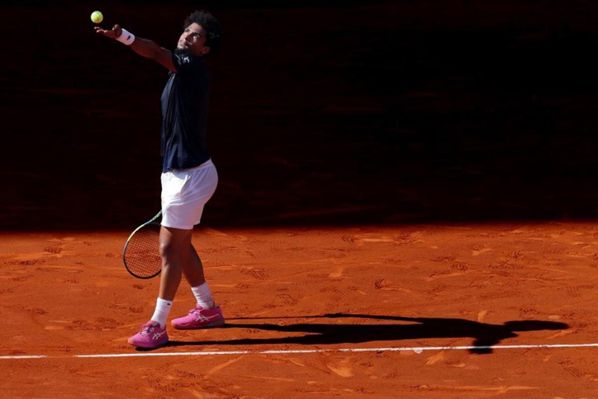France's Arthur Fils serves a ball to Italy's Jannik Sinner during their 2026 ATP Tour Madrid Open tennis tournament semi-final singles match at the Caja Magica in Madrid, on May 1, 2026.  Thomas COEX / AFP