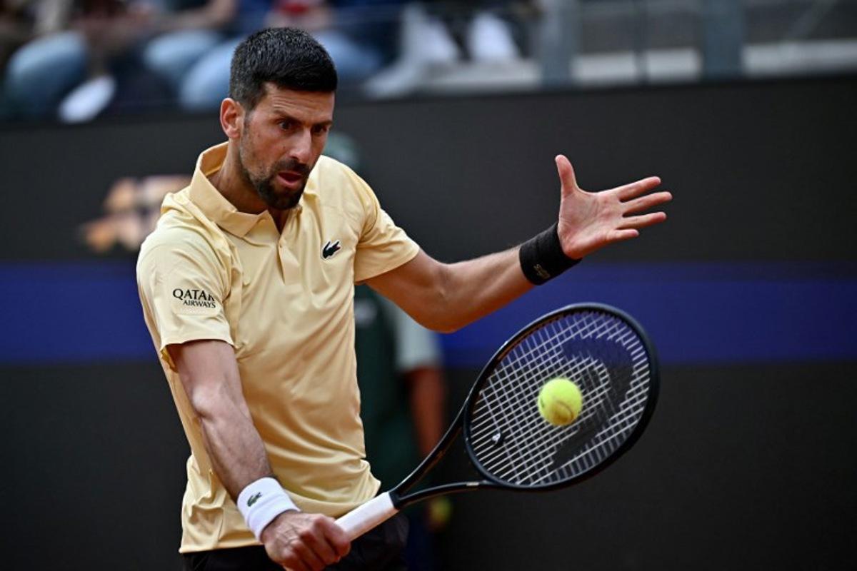 Serbia's Novak Djokovic plays a backhand return to Croatia's Dino Prizmic during their men's singles match of the WTA Rome Open tennis tournament at the Foro Italico in Rome on May 8, 2026.   Filippo MONTEFORTE / AFP