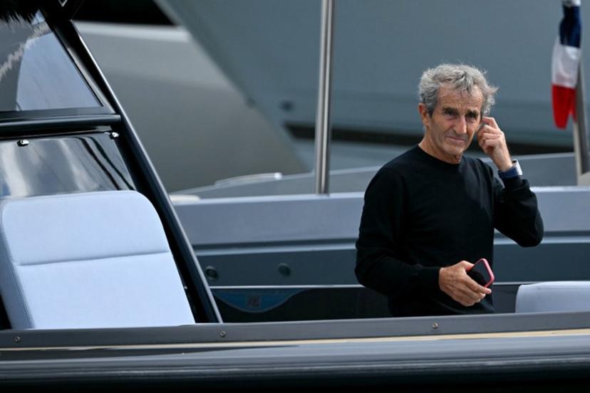 French former driver Alain Prost arrives by boat in the paddock of the Circuit de Monaco before the third practice session of the Formula One Monaco Grand Prix on May 25 2024, on the eve of the race.  NICOLAS TUCAT / AFP