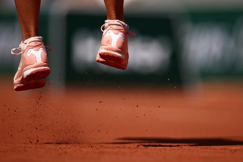 Clay falls from the sneakers of jumping Poland's Magda Linette as she plays against Canada's Leylah Fernandez during their women's singles match on day one of the Roland-Garros Open tennis tournament at the Court Simonne-Mathieu in Paris on May 28, 2023.  Anne-Christine POUJOULAT / AFP