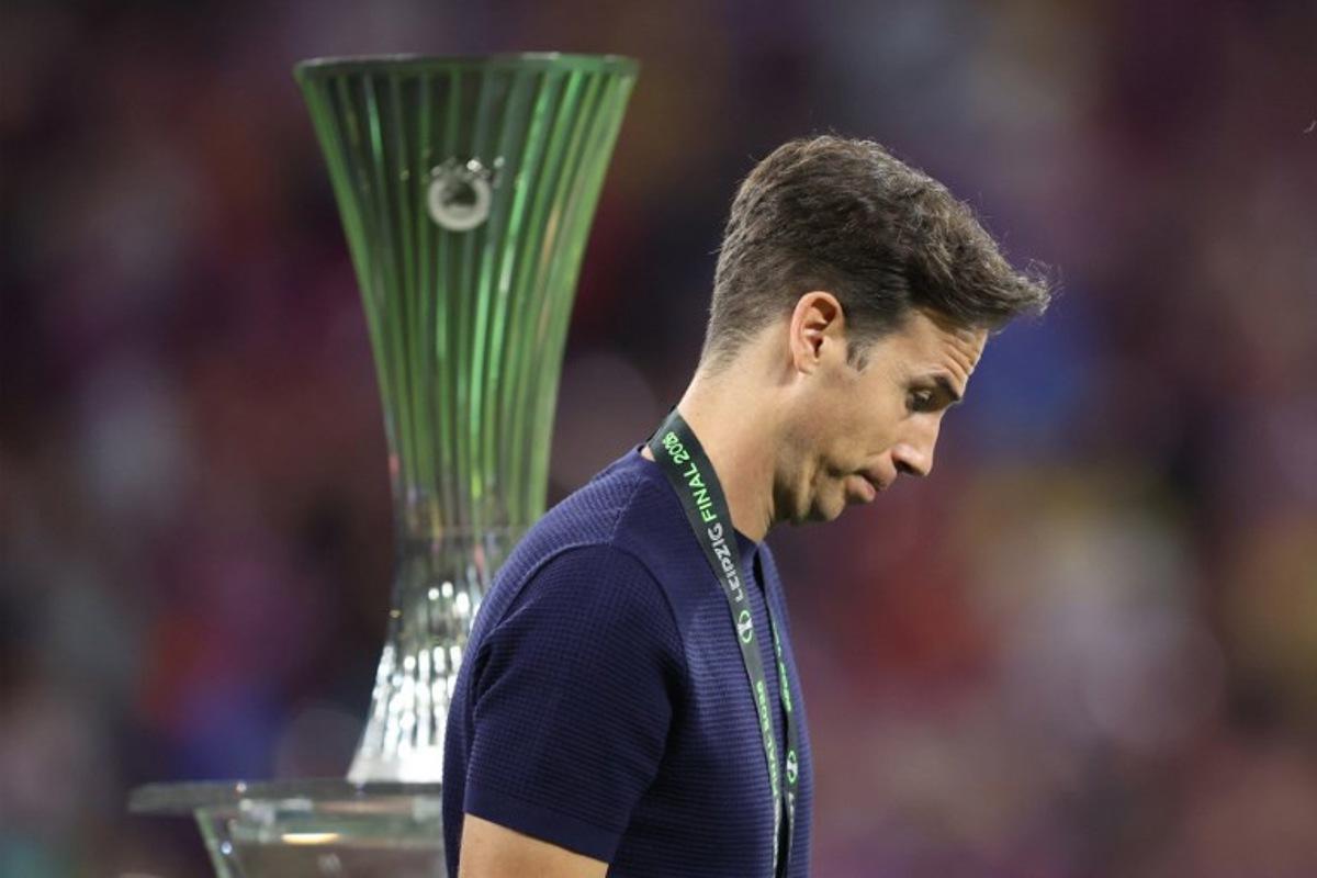 Rayo Vallecano's Spanish coach Inigo Perez reacts as he walks past the trophy after his team lost the UEFA Conference League final football match between Crystal Palace FC and Rayo Vallecano de Madrid in Leipzig, eastern Germany, on May 27, 2026.    Ronny HARTMANN / AFP