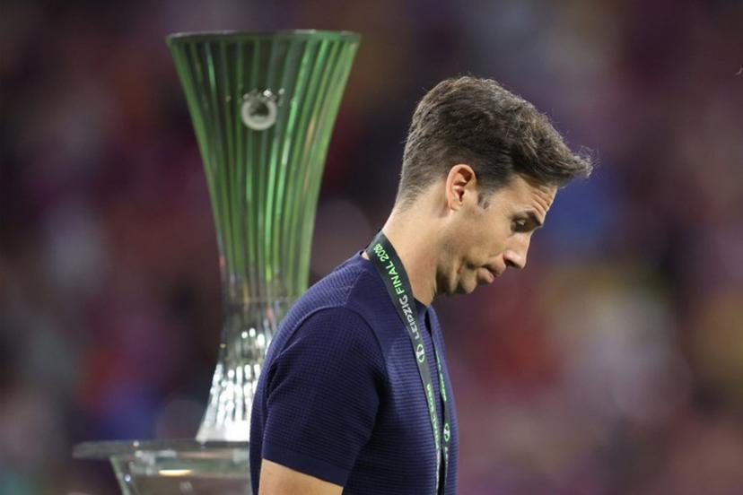 Rayo Vallecano's Spanish coach Inigo Perez reacts as he walks past the trophy after his team lost the UEFA Conference League final football match between Crystal Palace FC and Rayo Vallecano de Madrid in Leipzig, eastern Germany, on May 27, 2026.    Ronny HARTMANN / AFP