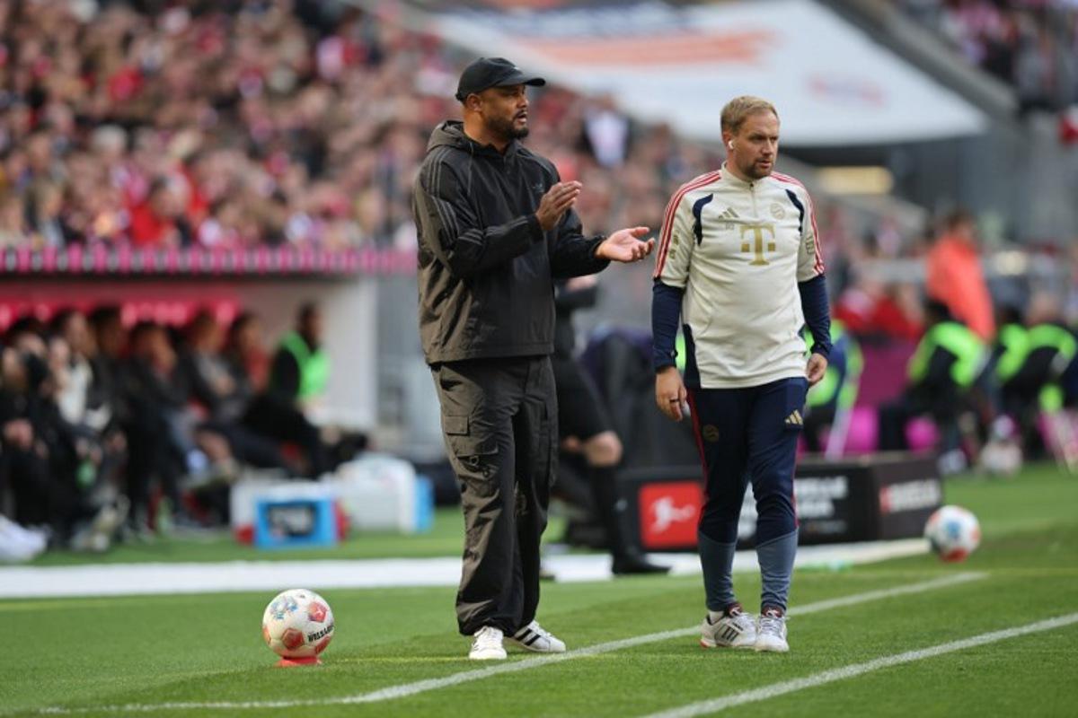 Bayern Munich's Belgian head coach Vincent Kompany (L) and FC Bayern Munich's English assistant coach Aaron Danks are seen on the sidelines during the German first division Bundesliga football match between FC Bayern Munich and FC Cologne in Munich, southern Germany, on May 16, 2026.  Alexandra BEIER / AFP