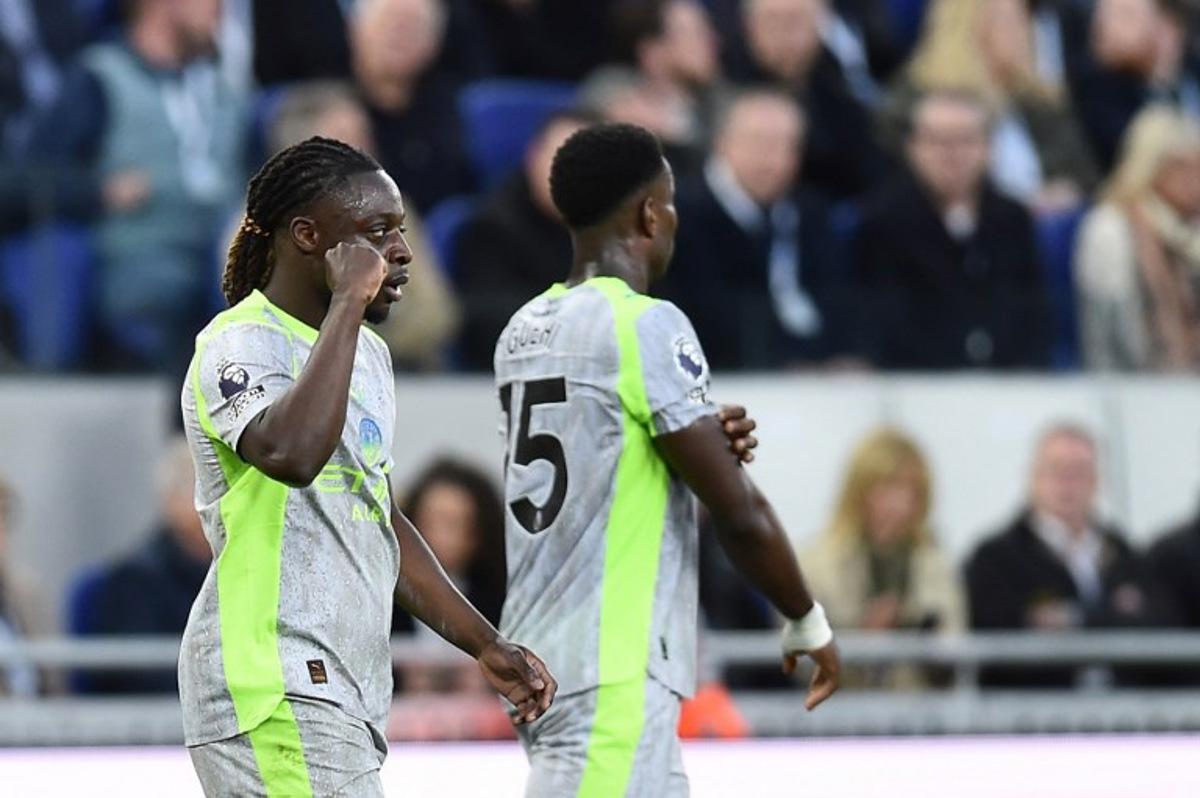 Manchester City's Belgian midfielder #11 Jeremy Doku celebrates after scoring the opening goal during the English Premier League football match between Everton and Manchester City at Hill Dickinson Stadium in Liverpool on May 4, 2026.  PETER POWELL / AFP