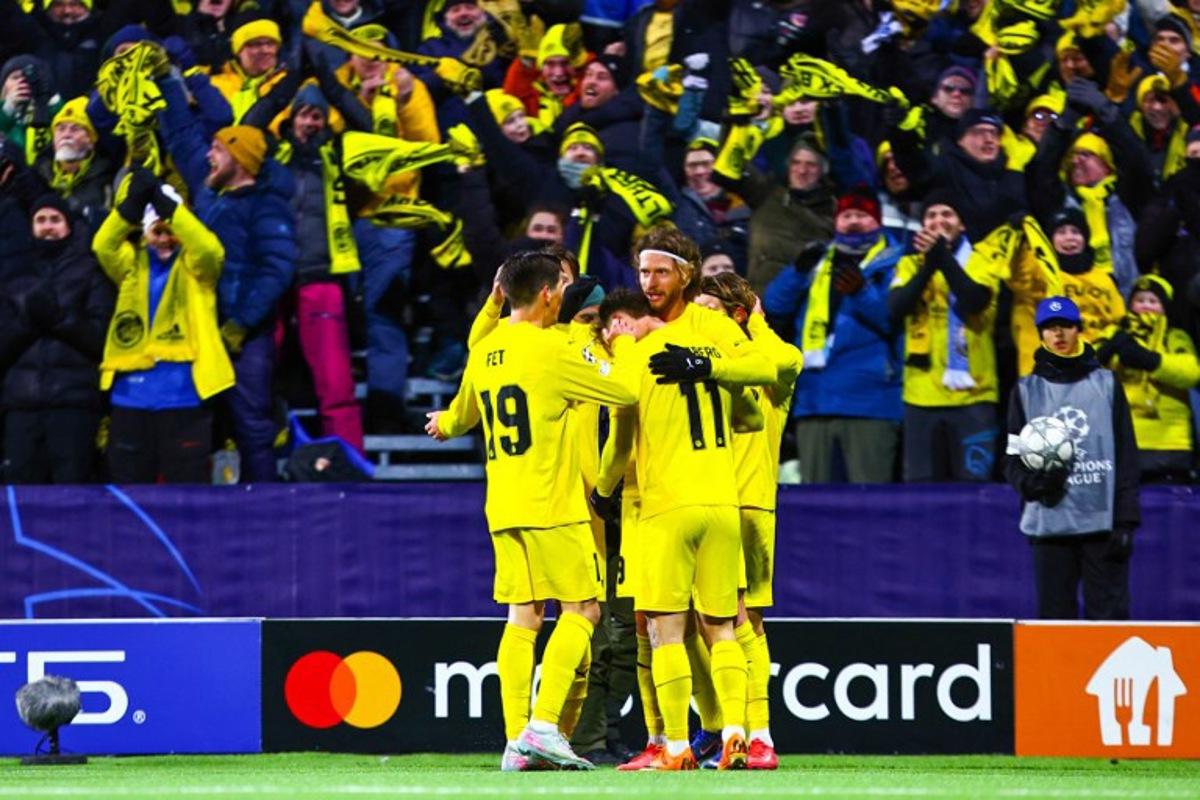Bodoe/Glimt's Danish forward #09 Kasper Waarst Hogh celebrates scoring his team's first goal with his team mates during the UEFA Champions League, league Phase - day 7 football match between Bodoe/Glimt and Manchester City in Bodoe, Norway on January 20, 2026.  Mats Torbergsen / NTB / AFP