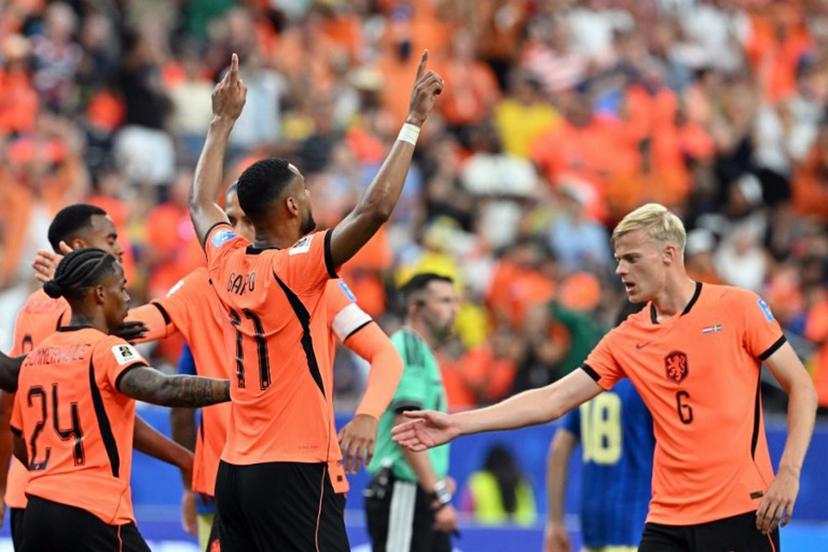 Netherlands' forward #11 Cody Gakpo (C) celebrates scoring his team's fourth goal during the 2026 World Cup Group F football match between the Netherlands and Sweden at the Houston Stadium in Houston on June 20, 2026.   RONALDO SCHEMIDT / AFP