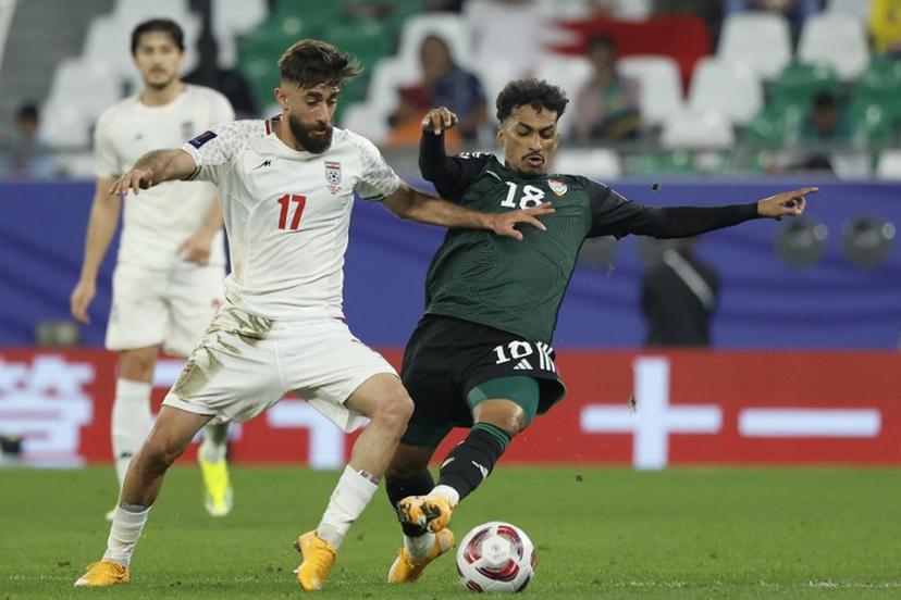 Iran's midfielder #17 Ali Gholizadeh vies for the ball against UAE's midfielder #18 Abdullah Ramadan during the Qatar 2023 AFC Asian Cup Group C football match between Iran and United Arab Emirates at Education City Stadium in al-Rayyan, west of Doha, on January 23, 2024.  KARIM JAAFAR / AFP